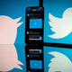 The Twitter logo displayed on a phone.